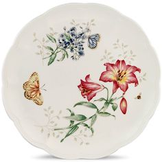 a plate with flowers and butterflies painted on it