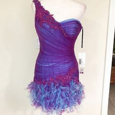 Enzoani Ruffled Teal Satin Underlay With Purple Netted Rushing Dress, One-Shoulder Statement Sleeve, And Corset Back Closure. Purple Blue Size 2 | Bust 15" Waist 13" Hips 18" Length 23" Mini To Knee-Length, Depending On Your Height New Condition With Tags. If You're Curious Yet Undecided, Ask For Additional Information And Pictures. Open To Offers. Sales Are Final. Capriciously, Tt Fri Purple Fitted One-shoulder Mini Dress, Fitted One-shoulder Purple Dress, Purple Fitted One-shoulder Dress, Purple One-shoulder Fitted Evening Dress, Purple Fitted One-shoulder Evening Dress, Purple One-shoulder Dress For Wedding, Rushing Dress, Enzoani Blue, Midi Formal Dress