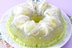 a bundt cake sitting on top of a white plate next to a purple wall