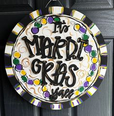 a mardi gras sign hanging on the front door