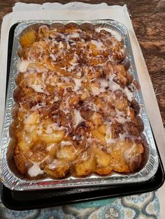 a casserole dish sitting on top of a table covered in icing and toppings