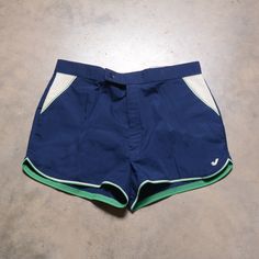 "Classic Jantzen tennis trunks. Excellent vintage condition. Labeled as a 40. Please see actual measurements below.  Waist: 38\" Outseam: 13.5\" Inseam: 2.5\" If you would like to see additional photos or have any other questions, please do not hesitate to ask, and thanks for looking! Shipping disclaimer: All domestic orders under 16oz ship USPS Ground Advantage. All domestic orders over 16oz ship USPS priority mail. All international orders under 4lbs ship via Etsy's Global Shipping Program. Al Blue Athletic Nylon Shorts, Vintage Mens Running Shorts, Blue Compressive Athletic Shorts Sportswear, Vintage Blue Sports Shorts, Vintage Blue Bottoms With Built-in Shorts, Tennis Shorts, Vintage Tennis, Gay Aesthetic, White Green