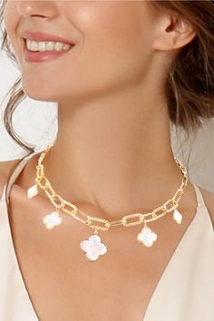 Add a touch of charm to any outfit with our Graduated Quatrefoil Necklace! This gold plated beauty features 5 charms of varying sizes, with the largest at the center. Lead and nickel compliant, with a 15.5" chain with a 2" extension. Pendant sizes range from 0.8" to 0.5". Note: The white is mother of pearl and turquoise is a faux turquoise stone. Gold-tone Metal Charm Necklaces, White Metal Jewelry With Flower Charm, White Adjustable Chain Necklace, White Charm Necklace With Delicate Chain, White Metal Charm Necklace With Delicate Chain, White Pendant Jewelry With Gold Chain, White Gold Chain Pendant Jewelry, White Gold Plated Charm Necklace With Adjustable Chain, White Gold-plated Charm Necklace With Adjustable Chain