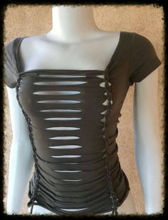 a mannequin wearing a black top with cut outs