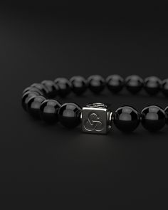 Experience simplicity at its finest with the Essential Bracelet. This piece embodies the elegance of minimalism, crafted for those who find beauty in understatement. It's a subtle yet powerful expression of self, perfect for visionaries who appreciate the grace in simplicity and make their mark with a quiet yet impactful presence. All our stones are chosen by hand to satisfy AAA quality standards. They are natural stones and their size and color can vary slightly. Stone: AAA Grade 8mm Metal: 925 Classic Sterling Silver Bracelet With Beads, Timeless Black Bracelets For Everyday, Timeless Black Everyday Bracelets, Classic Black Beaded Bracelets, Classic Onyx Bracelets With Round Beads, Minimalist Black Sterling Silver Beaded Bracelets, Minimalist Black Sterling Silver Bracelet, Classic Silver Onyx Bracelets, Classic Round Onyx Bracelet