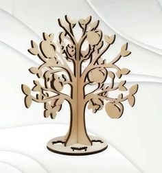 a wooden cutout of a tree with many leaves and birds on it's branches