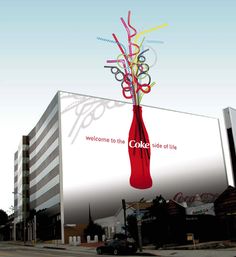 a large billboard with a red vase filled with colorful plastic straws on it's side