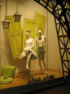 two mannequins dressed in white and green sitting next to each other