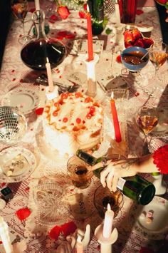 a table topped with lots of food and candles