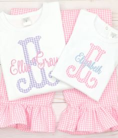 This sweet shirt & ruffle pant set is made from our bright pink gingham fabric & paired with a periwinkle blue embroidered name. Purple gingham pant set available too, please message us! Our white boutique bodysuits & shirts are the highest quality on the market. They are thick, soft & beautifully constructed. They run true to size. We recommend to size up if unsure. Our ruffle pants are made from beautiful, high quality, floral printed fabric. They have an elastic waistband &amp Spring Family Matching Pink Sets, Family Matching Pink Sets For Spring, Pink Monogrammed Cotton Top, Pink Monogram Cotton Top, Personalized Pink Tops For Spring, Personalized Fitted Pink Tops, Personalized Pink Top For Spring, Pink Top For First Birthday In Spring, Pink Tops For First Birthday In Spring