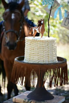 there is a horse and a cake on the table