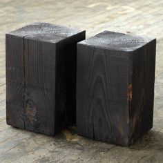 two pieces of wood sitting on top of a wooden floor next to eachother