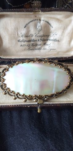 Antique Vintage Victorian Large Mother of Pearl Brooch - Very Rare and Beautiful VINTAGE, beautiful, large, brass bobble and filigree framed brooch with gorgeous natural Mother of Pearl shell centre with a really stunning green/pink/blue aurora borealis lustre, best seen in the photos with the black background. Nice condition. Clasp:      Roll over locking clasp and pin in tact. SIZE: Approx: 5.5 cm x 3 cm  Good condition as shown BOX NOT INCLUDED BUT WILL BE SHIPPED IN NICE VELVET POUCH BAG FRE Blue Aurora, Blue Aurora Borealis, Pearl Brooch, Velvet Pouch, Vintage Victorian, Pearl Shell, Baroque Pearls, Pouch Bag, Aurora Borealis