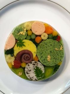 a white plate topped with lots of different types of food on top of each other