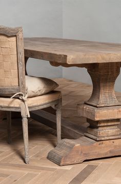 an old wooden table with two chairs around it