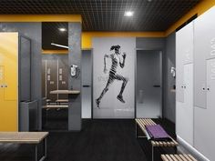 the interior of a gym with benches, lockers and an advertisement on the wall