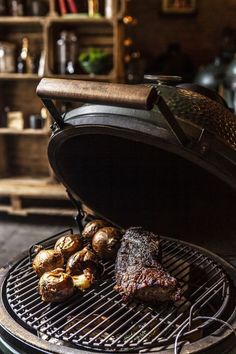 steak and potatoes cooking on an outdoor grill