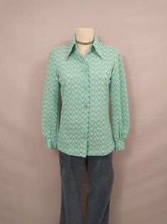 "Fun authentic vintage seventies dacron polyester blouse. Washable (washed, hang dry) . Full button down with classic shirt collar, long length. Double button on each wrist cuff. Size marked 14, vintage sizing is different - please go by measurements, it is on a 6 dress form and there is room.  Long sleeves. Condition very good, no stains or damage. Length 26\" Shoulders 17\" Bust 37\" Sleeve 23.5\" wt 7oz" Retro Collared Blouse For Work, Vintage Cotton Shirt With Collared Neckline, Vintage Cotton Blouse With Collared Neckline, Vintage Green Button-up Shirt, Retro Collared Shirt With Vintage Pattern, Retro Long Sleeve Blouse For Vintage Fashion, Retro Fitted Shirt For Daywear, Vintage Cotton Button-up Blouse, Retro Spring Button-up Shirt