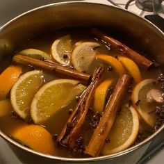 a pot filled with lemons and cinnamon sticks