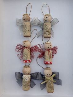 two wooden peg dolls are hanging from twine