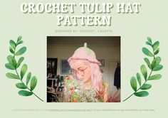 a woman with pink hair wearing a knitted hat and green leaves around her neck