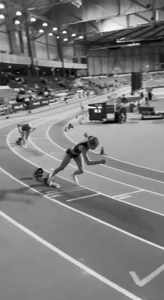 black and white photograph of athletes on track