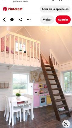 there is a loft bed with stairs to the second floor and a table in front of it