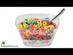 a bowl full of cereal with a spoon sticking out of the top and colorful cereal in it