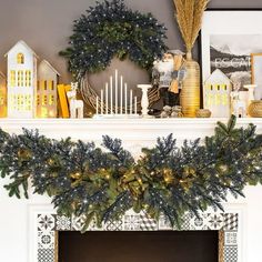 a mantel decorated with christmas decorations and greenery