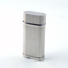 a silver lighter on a white background with the lid off and no one around it