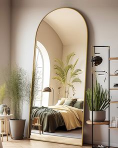 a bedroom with a large mirror on the wall next to a bed and potted plants