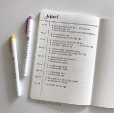 an open notebook with some writing on it next to a pen and paper that says june