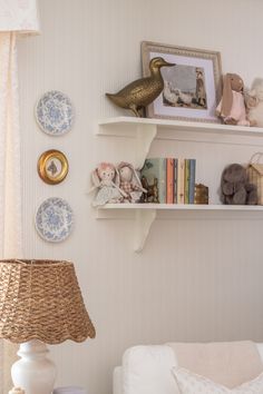 a living room filled with furniture and decor on top of bookshelves next to a window