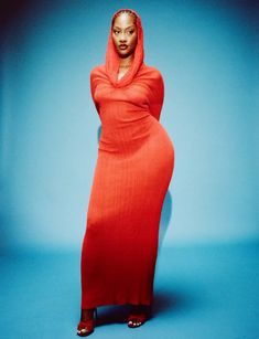 a woman in a red dress posing for a photo