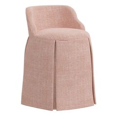 an upholstered chair with a pleaed skirt on the bottom and back side