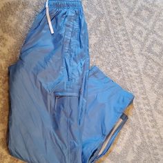 Swishy Brand New Condition Pants. Mesh Interior. Side Pockets. Zip At Ankles. 90s High Waist Blue Pants, 90s Style High Waist Blue Pants, 90s Blue Bottoms With Cargo Pockets, 90s Style Blue Bottoms With Cargo Pockets, 90s Blue Cargo Bottoms, 90s Style Blue Cargo Bottoms, Blue Full-length Parachute Pants With Side Pockets, 90s Style Blue Bottoms With Relaxed Fit, Sporty Blue Parachute Pants For Summer