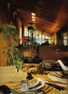 a living room filled with furniture and plants