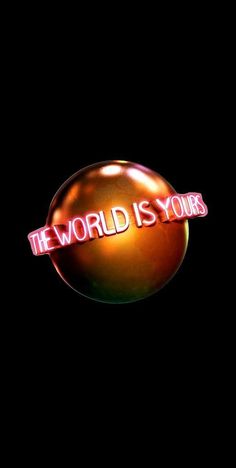 the world is yours sign lit up against a black background