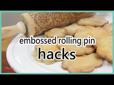 a white plate topped with cut up cookies next to a rolling pin that says, embossed rolling pin hacks