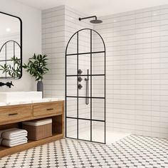 a white tiled bathroom with black and white tile flooring, two mirrors on the wall