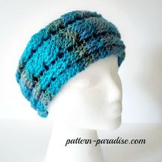 a white mannequin head wearing a blue knitted hat on top of it