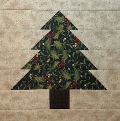 a quilted christmas tree with holly and berries