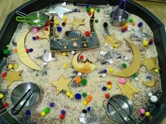 a tray filled with sand and spoons on top of a table