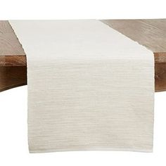 a white table runner on top of a wooden table