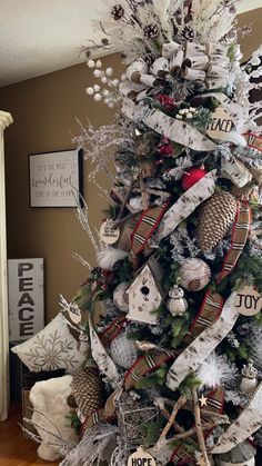 a christmas tree decorated with ribbons and ornaments