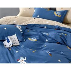 an image of a bed with blue comforter and pillows on it's side