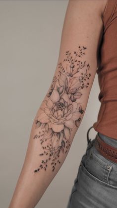 a woman with a flower tattoo on her arm