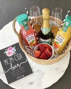 the mother's day gift basket is filled with fruit and juice