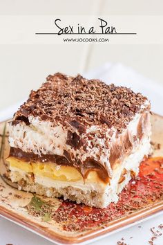 a piece of dessert sitting on top of a brown and white plate next to a fork