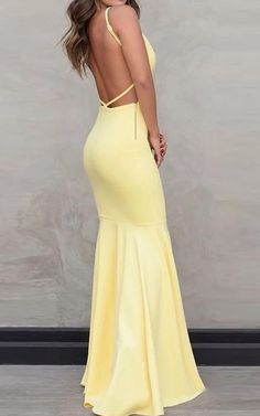 a woman in a yellow dress with her back to the camera